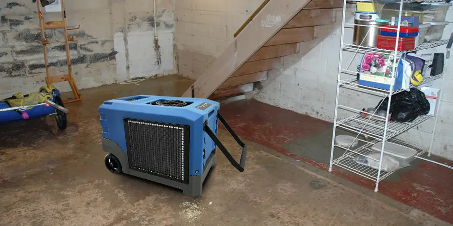 Dehumidifier set beside the stairs of a basement during water cleanup