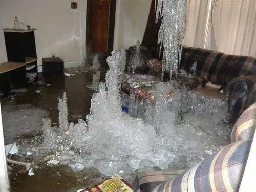 Ice and water covering a living room after a frozen pipe burst in a Fresh Meadows home